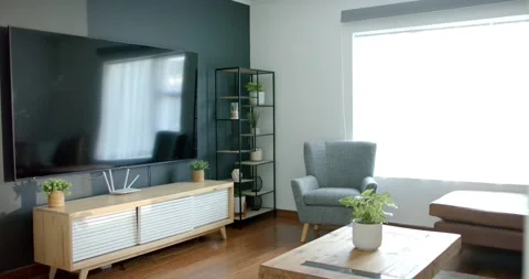 Camera is panning to reveal left edge, showing wall TV and console while Stock Footage 335199575
