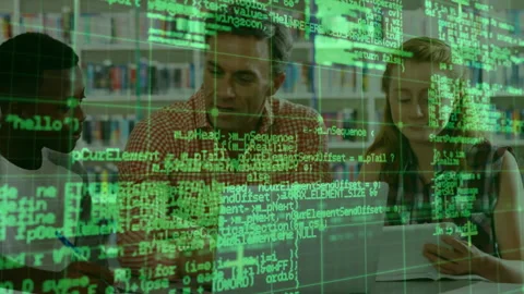 Camera panning revealing mentor guiding students in coding exercise with green Video stock 314175062
