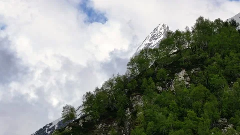 Camera panning up revealing mountain peak Stock Footage 289680176