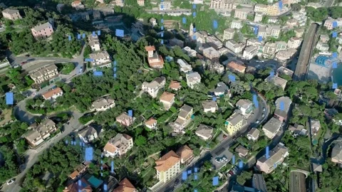 Camera panning right after takeoff, revealing hillside homes, promenade and Stock Footage 333592972