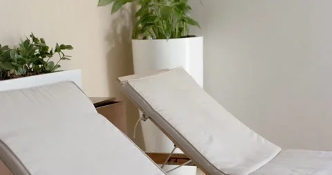 Camera panning right and upward in spa lounge, revealing two recliners and Stock Footage 344671766