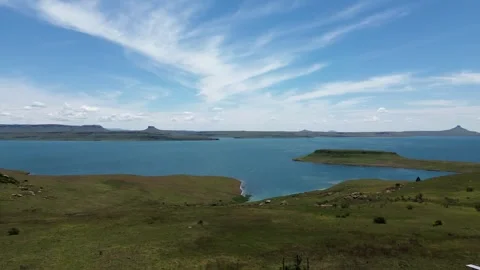 Camera panning right to left over the length of the Sterkfontein dam with the fo Stock Footage 325648850