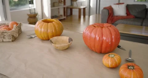 Camera is panning right, moving closer, showing pumpkins, wooden bowl forming Stock Footage 345090383
