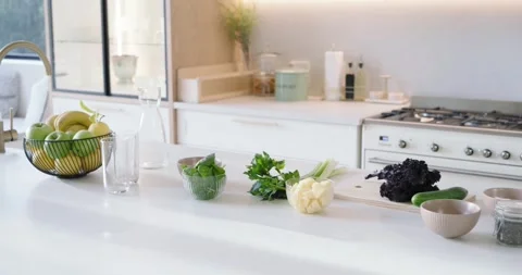Camera is panning right, revealing counter produce and blender in bright kitchen Video stock 344678490