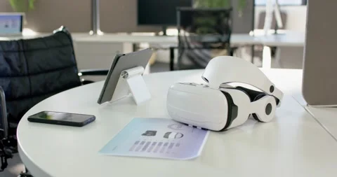 As camera is panning right, VR headset is staying on table, computer monitors Stock Footage 317660829