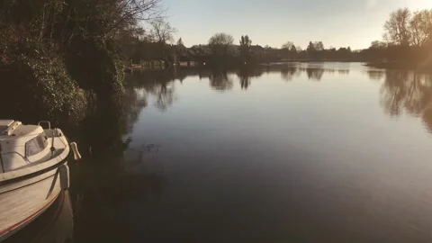 Camera panning from small boat to sunset over La Sarthe River in France Video stock 266512670