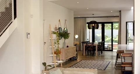 Camera is panning from sofa, showing open living-dining area with table and Stock Footage 340257127