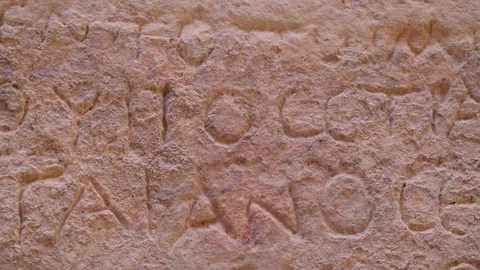 Camera panning through the ancient wall engraving in Petra Stock Footage 102448980