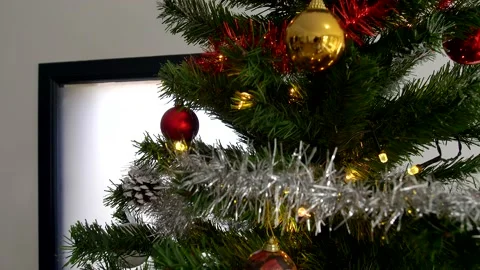 Camera panning through Christmas tree showing decorations Stock Footage 140472051