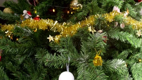 Camera panning through Christmas tree showing star topper Stock Footage 140475398