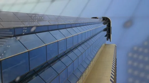 Camera panning tower, tech feed driving code and dotted map overlay across glass Stock Footage 332405690