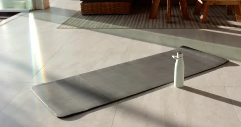 Camera is panning upward to reveal gray mat and white bottle near door, exposing Stock Footage 344463316