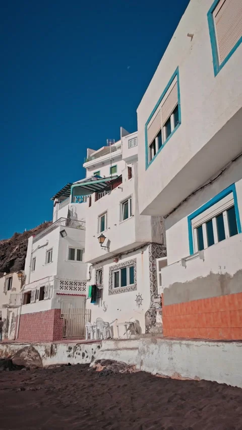 Camera panning up white beachfront building facade Stock Footage 294278301