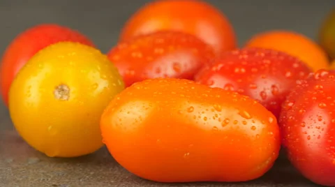 Camera pans across assorted cherry tomatoes with water drops Stock Footage 65727809