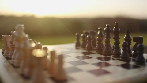 Camera pans across a chess board on an old wooden bench outdoors Stock Footage 89569795