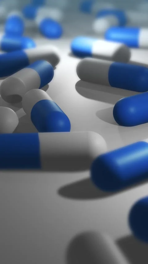 Camera Pans Across Cinematic Blue and White Pill or Drug Capsules - Vertical Видео 331550729