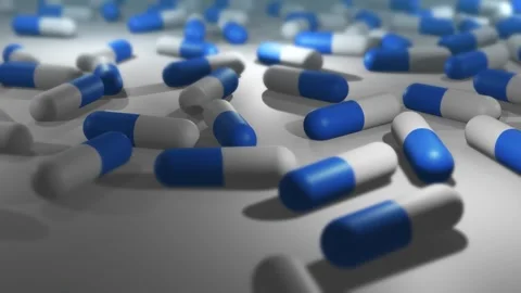 Camera Pans Across Cinematic Blue and White Pill or Drug Capsules Vídeos de archivo 331550737