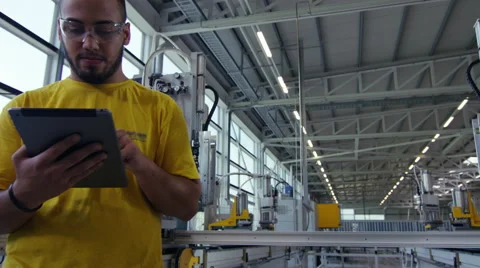 Camera pans across to create a Portrait of factory worker Stock Footage 63029657