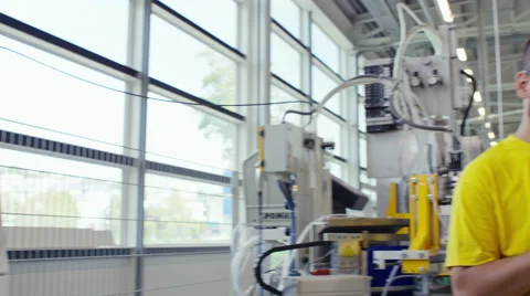 Camera pans across to create a Portrait of factory worker using a tablet Stock Footage 63031893