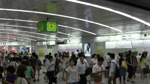 Camera pans across a crowded busy area of Shinjuku station in Tokyo Japan Stock Footage 47329399