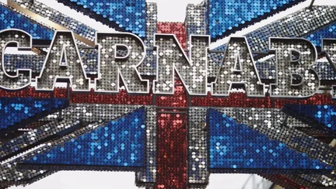 Camera pans across a flashy sign showing off London's Carnaby Street shopping di Vídeos de archivo 84636661