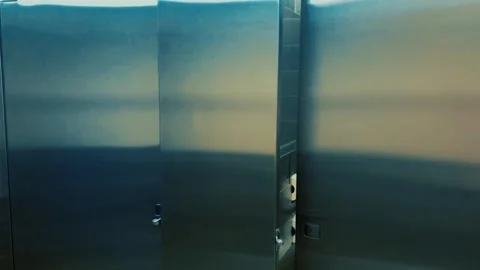 Camera pans across modern bathroom stalls in womens bathroom - Ominous color Stock Footage 307189067