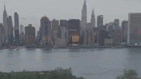 Camera pans across new york skyline in summer at dawn Stock Footage 326705579