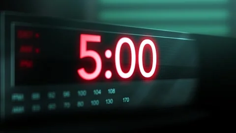 Camera pans across old digital clock as time arrives at 5 AM Stock Footage 306527692