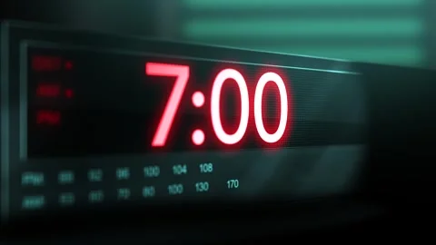 Camera pans across old digital clock as time arrives at 7 AM Stock Footage 306527700