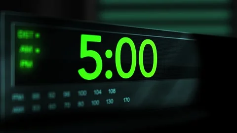 Camera pans across old digital clock as time arrives at 5 AM - Green Version Stock Footage 306557946
