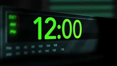 Camera pans across old digital clock as time arrives at 12 AM - Green Versio Stock Footage 306659896