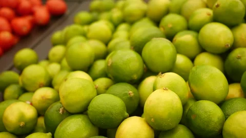 Camera pans across a pile of Limes in Grocery Store Stock Footage 289403376