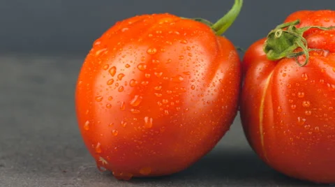 Camera pans across red tomatoes with water drops Stock Footage 65728048