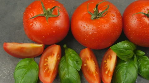 Camera pans across red tomatoes and basil with water drops Stock Footage 65728249
