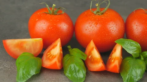 Camera pans across red tomatoes and basil with water drops Stock Footage 65728264