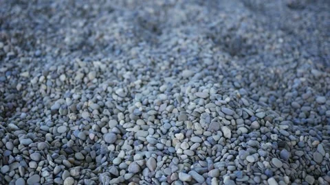 Camera pans across rocks and pebbles on the ground Stock Footage 347033946