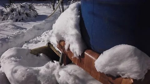 The camera pans across the snow-covered garden of a private house. Vídeos de archivo 169492941