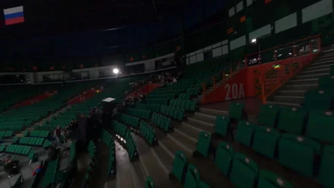 Camera pans across stadium seats capturing extras and film crew in action Video stock 303277822