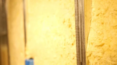 Camera pans across yellow padding insulation Stock Footage 95480518