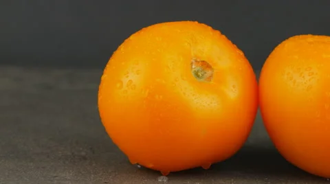 Camera pans across yellow tomatoes with water drops Stock Footage 65727780