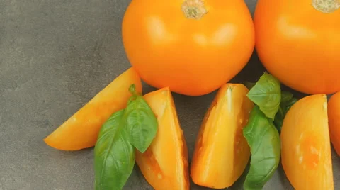 Camera pans across yellow tomatoes and basil Video stock 65728163