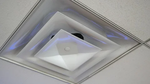 Camera pans to air vent cover on office ceiling Stock Footage 94549038