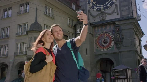 Camera pans around couple as they kiss while in the city. Video stock 63023386