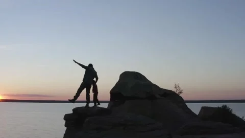 The camera pans around the man with his son Видео 157762458