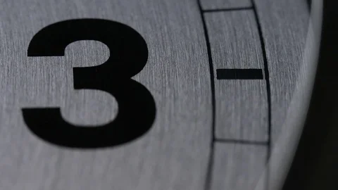 Camera pans around the numbers on a clock face until it stops at 3 Stock Footage