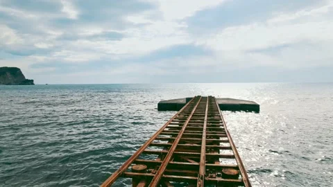 The camera pans back along the metal structure on the beach Stock Footage 224069854