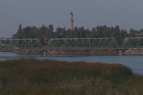 Camera pans from bridge over the Euphrates River, over Fallujah skyline. Stock Footage 86753466