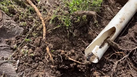 Camera pans to broken dug up gutter near residential home - Contractor work Stock Footage 307152897