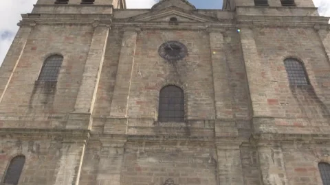 Camera Pans Up Catholic or Orthodox Christian Church to Blue Sky Stock Footage 325263136