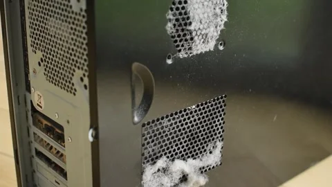 The camera pans down a black desktop PC case, revealing thick dust along its Stock Footage 347864875